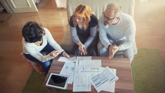 Couple going over finances with a consultant.